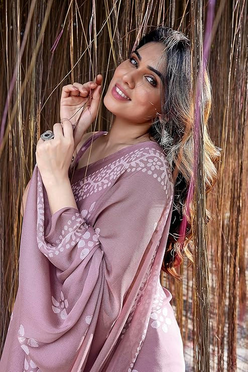 Thumbnail: Smiling woman in mauve dress, posing with a floral design Shopizo