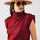 Thumbnail: Woman in maroon turtleneck sleeveless top, hat, and sunglasses