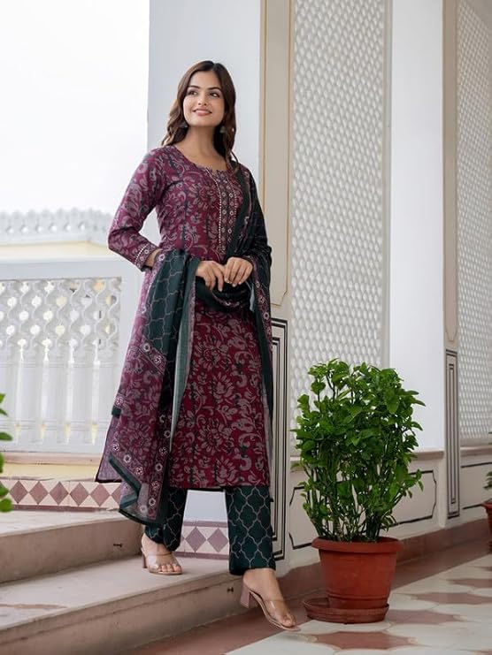 Woman wearing Women's Woolen Printed Kurta Palazzo Set With Floral Pattern, 3/4 Sleeve near plant. Shopizo