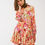 Thumbnail: Woman in floral print mini dress