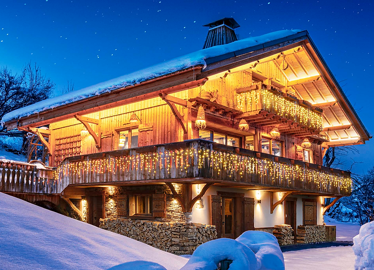 Megève chalet in winter, illuminated façade at night