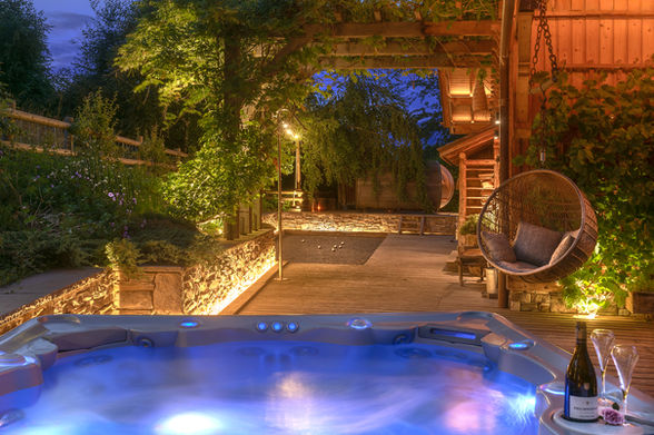 View of the garden of a mountain chalet with jacuzzi