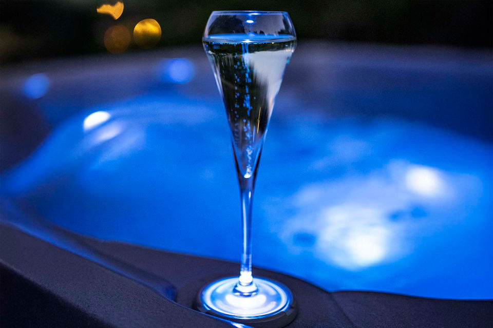 Champagne glass next to a hot tub on the terrace of a chalet in Haute-Savoie