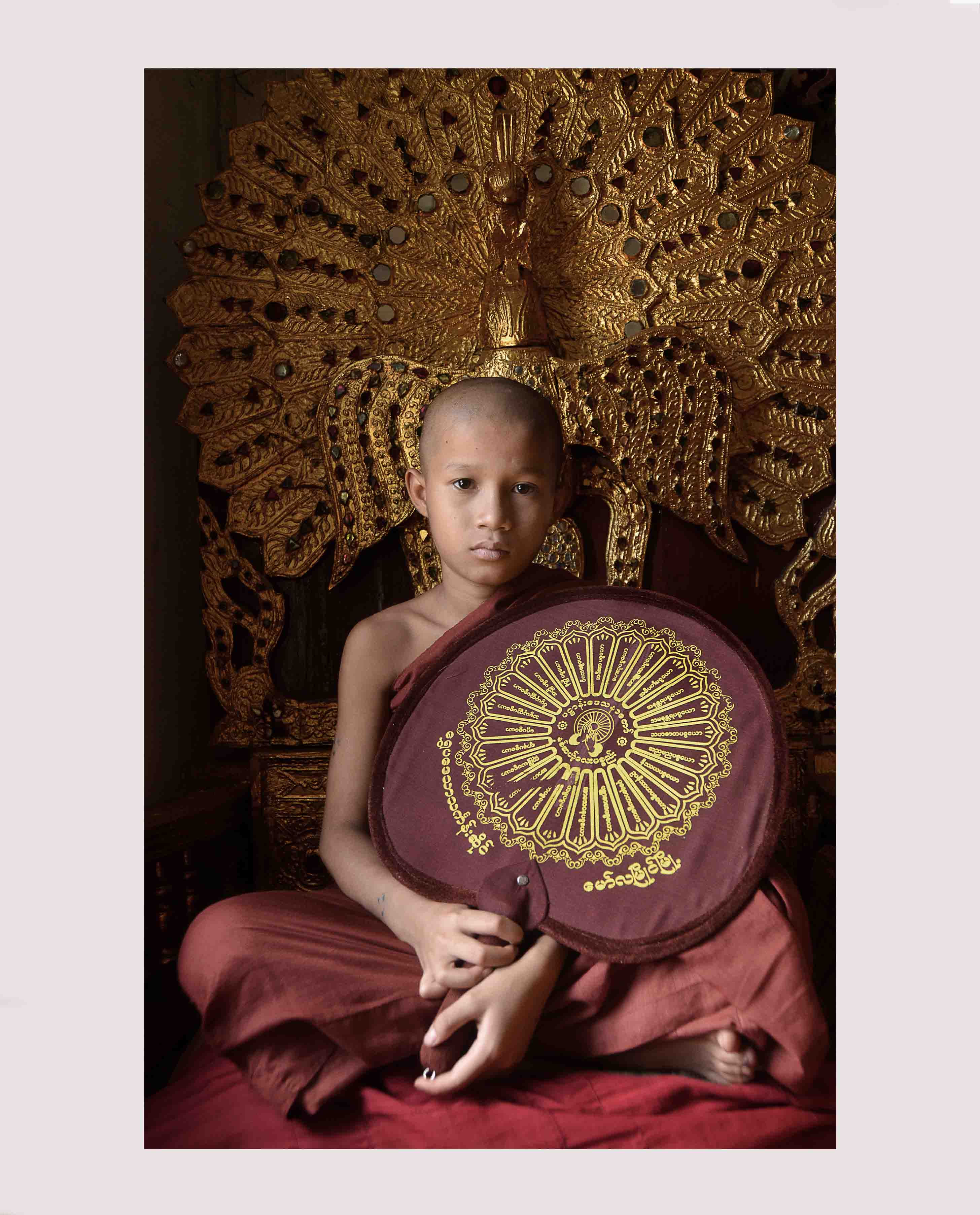 SEATED MONK WITH FAN