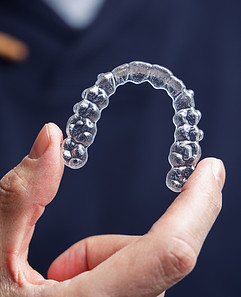 clear-aligners-for-teeth-straightening-being-held-2026-03-16-00-32-24-utc_edited.jpg