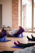 Small group prenatal yoga class at The HummingBee retreat, featuring serene countryside views and expert birth preparation.