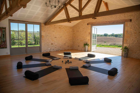 Meditation circle setup. Wood beams and stone walls. open bay doors on 3 sides