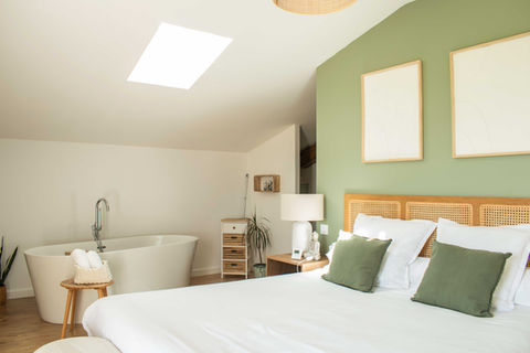 One of our retreat rooms featuring a freestanding bathtub, soft lighting, and natural stone accents—ideal for prenatal rest and relaxation.