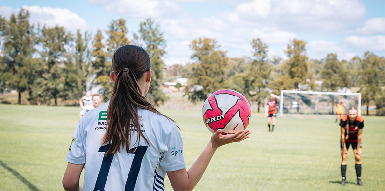 soccer player throwing the ball in