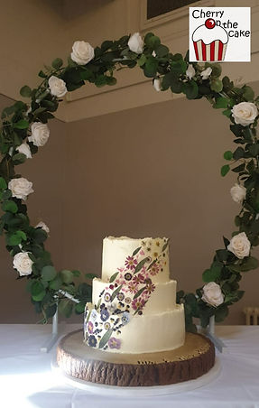 Buttercream tiered wedding cake with edible dried flowers