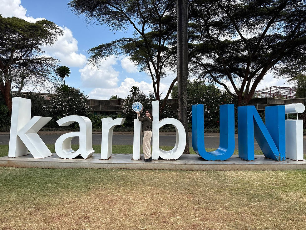 Grant at the UNEA-7 KaribUNi sign in Nairobi, Kenya.