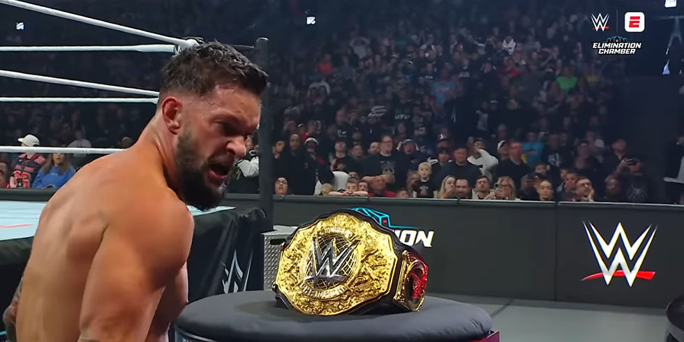 Finn Balor looking at the World Heavyweight Championship and looking back at CM Punk
