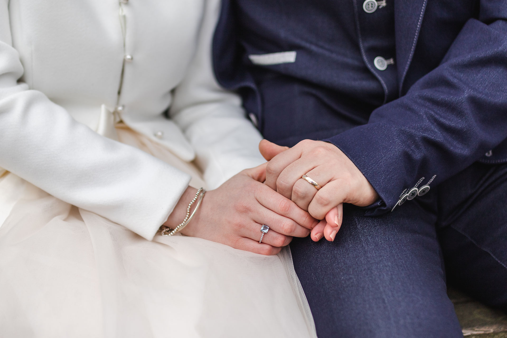 Close up wedding rings as bride and groom hold hands for Lincoln Cathedral Wedding portraits