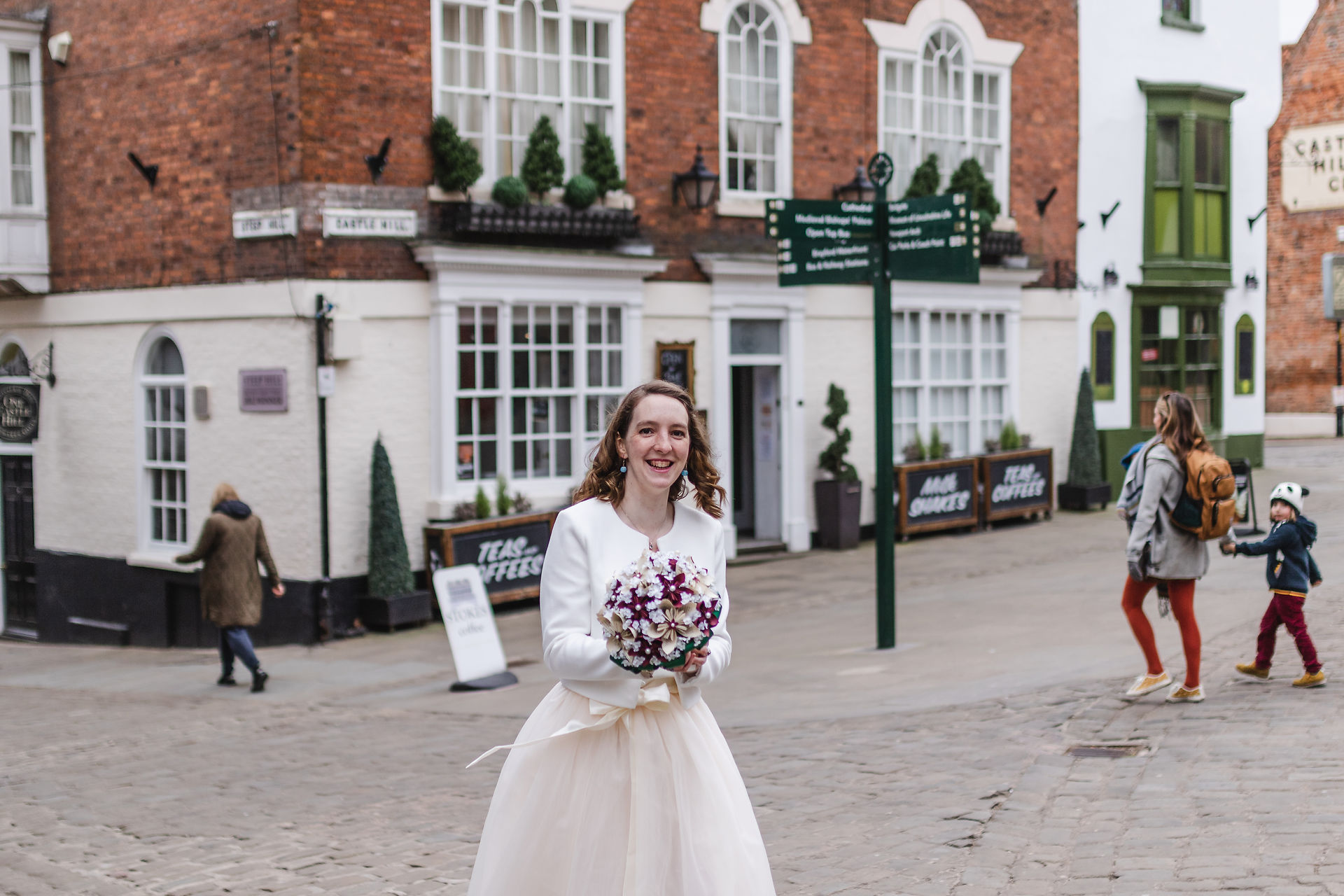 Portrait of Bride in tea length dress at the top of Steep Hill in Lincoln