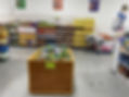 The image shows the inside of the Hope Center FRC shopping center with shelves of canned and boxed foods