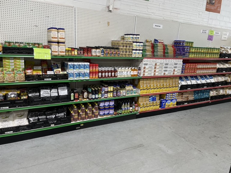 The image shows the shelves holding a variety of canned and boxed goods in the shopping area of the Hope Center Food and Resource Center.
