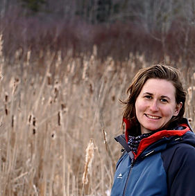 Your coach Linsay in a grainfield looking at you with a big smile.