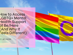 Three LGBTQIA+ flags – the pansexual flag, the inclusive Progress Pride flag, and the intersex flag – wave against a bright blue sky. Overlaid is a pink-framed box containing the blog title: “How to Access LGBTQ+ Mental Health Support at Be/Here (And Why It Feels Different)” by Be/Here. The image represents inclusive and affirming mental health support for queer and trans communities.