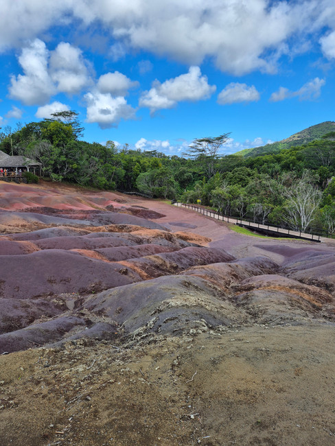 Colored earth. Hilly with blue sky