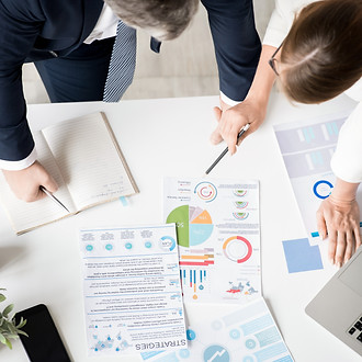 Business-partners-examining-data-561231.