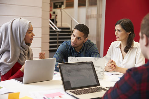 Graduate students listening to each other during an academic workshop