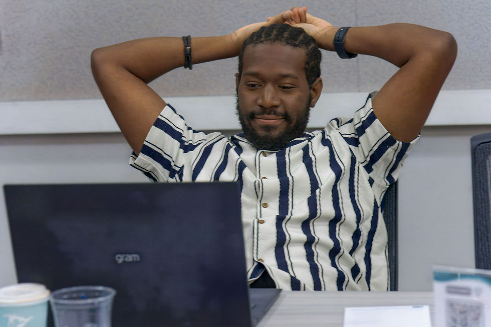 Academic writer takes a break from working on a laptop during a focused writing session.