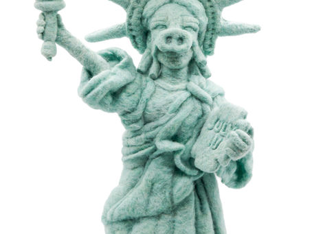 Needle felt of The Statue Of Liberty wearing a pig snout.