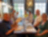 Zest Singles members enjoying a supper event at Cote Brasserie in Exeter, smiling at a table in a lively and sociable atmosphere.