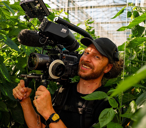 Director and Cinematographer Will Prosor filming in a hot house.