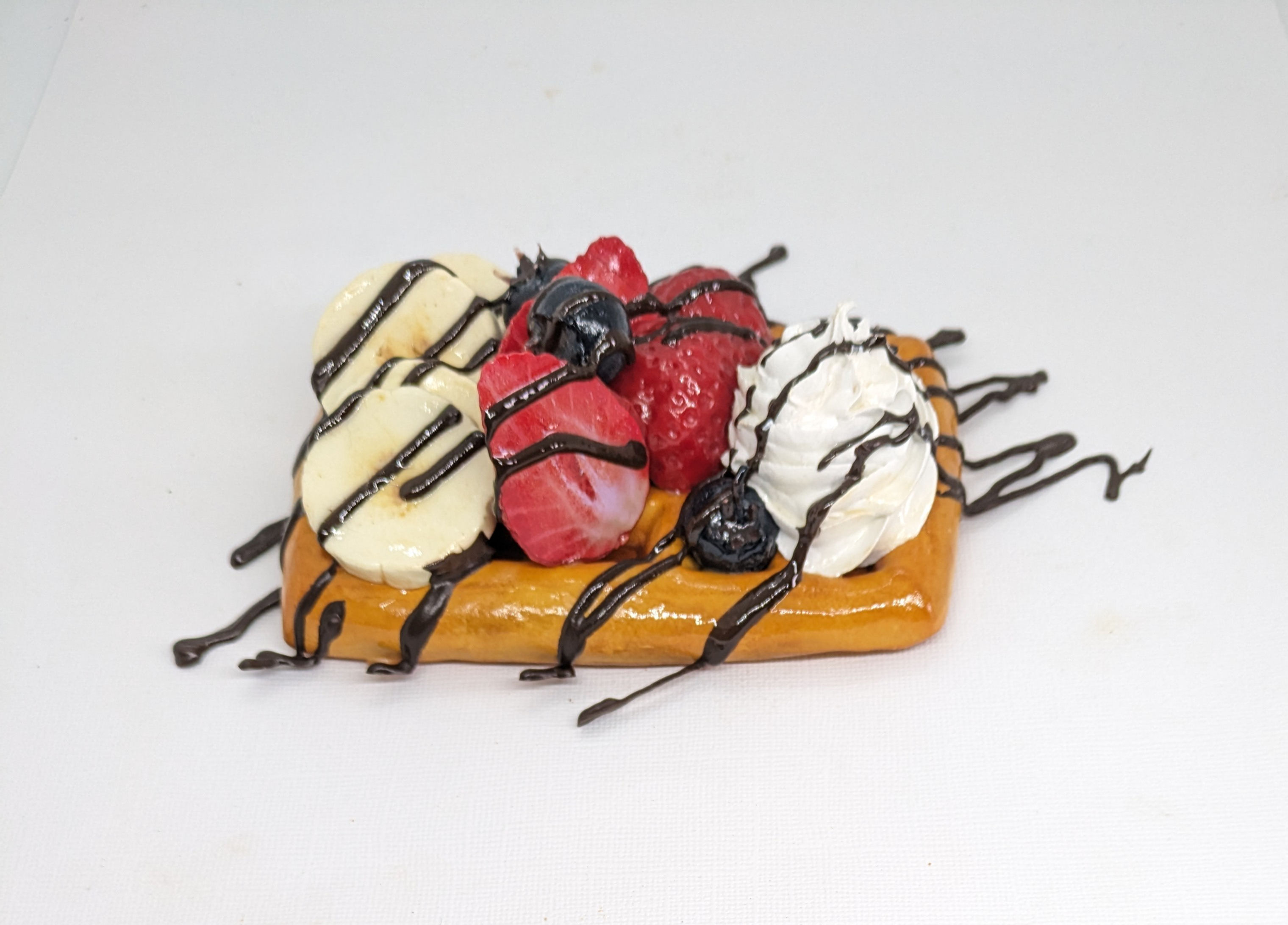 Fake Waffle with Banana, Strawberries, Blueberries, Cream & Chocolate Drizzle