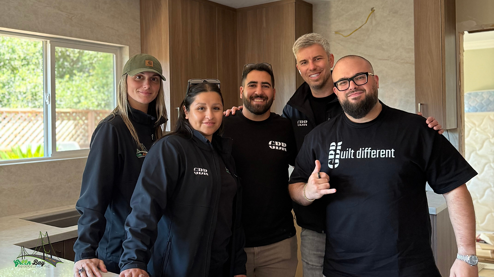 Green Bay Remodeling team standing together inside a newly remodeled home after completing a custom renovation project