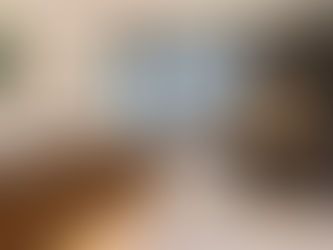 Modern bathroom remodel in Fremont featuring a double wood vanity, vessel sinks, freestanding soaking tub, walk-in shower, dark porcelain wall tile, illuminated mirrors, and warm niche lighting by Green Bay Remodeling.