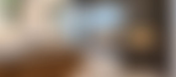 Modern bathroom remodel in Fremont featuring a double wood vanity, vessel sinks, freestanding soaking tub, walk-in shower, dark porcelain wall tile, illuminated mirrors, and warm niche lighting by Green Bay Remodeling.