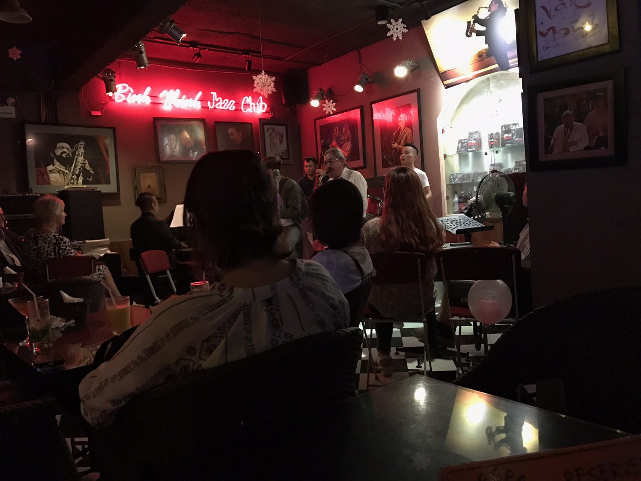 A dimly lit jazz club with a live band performing in Hanoi’s Old Quarter.