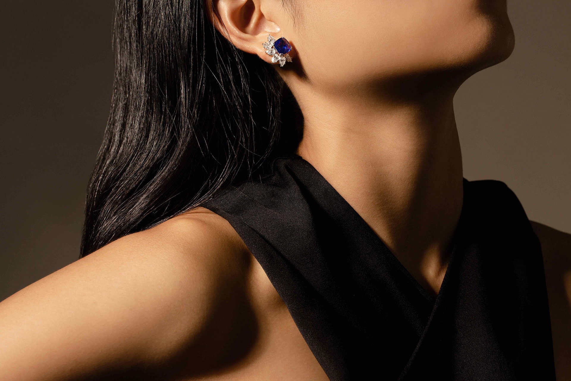 A model wearing a blue sapp earrings