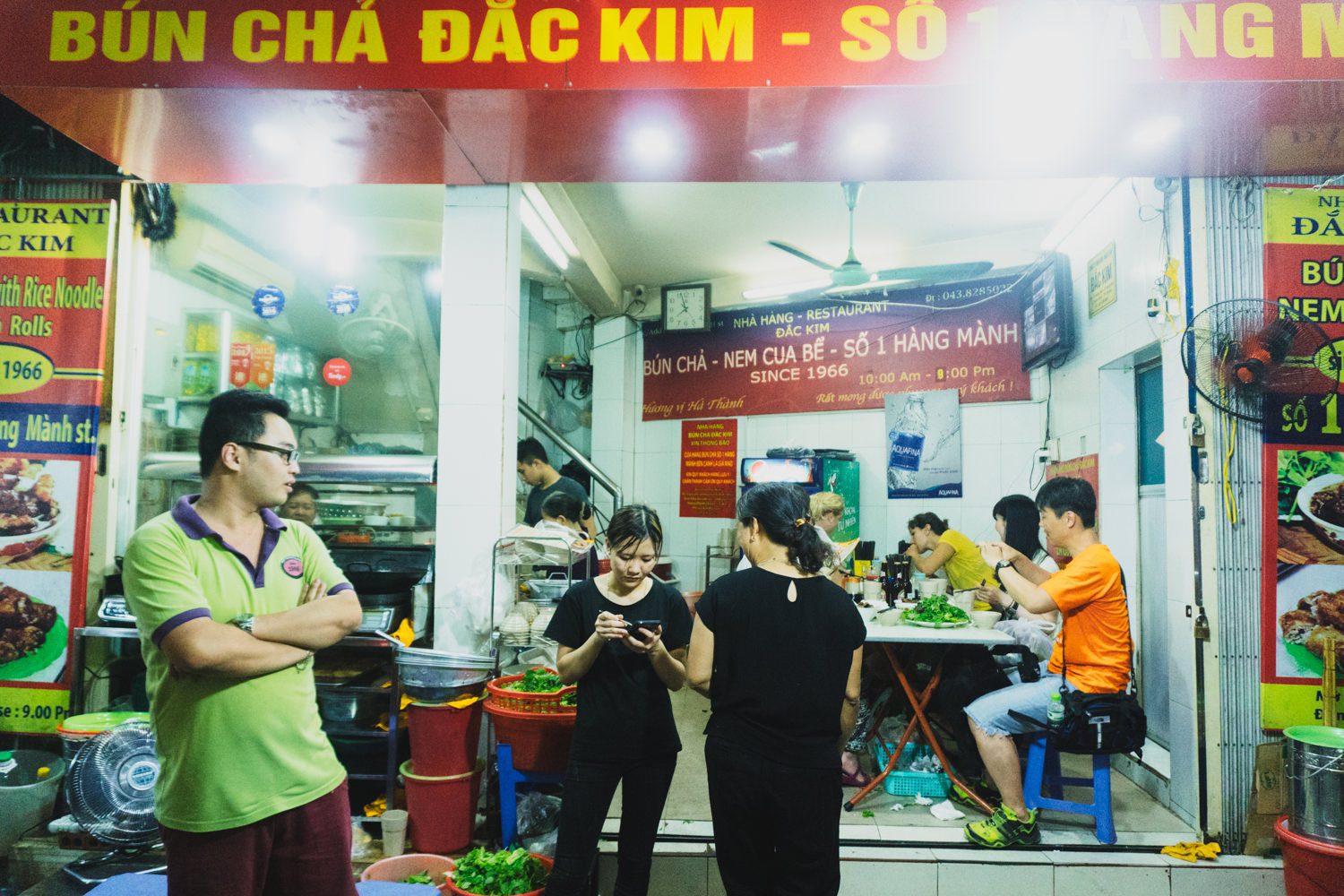 A vendor grilling pork patties for bun cha in Hanoi.