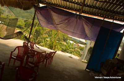 A traveler standing at the edge of a scenic viewpoint, overlooking a deep valley and winding roads in Vietnam.