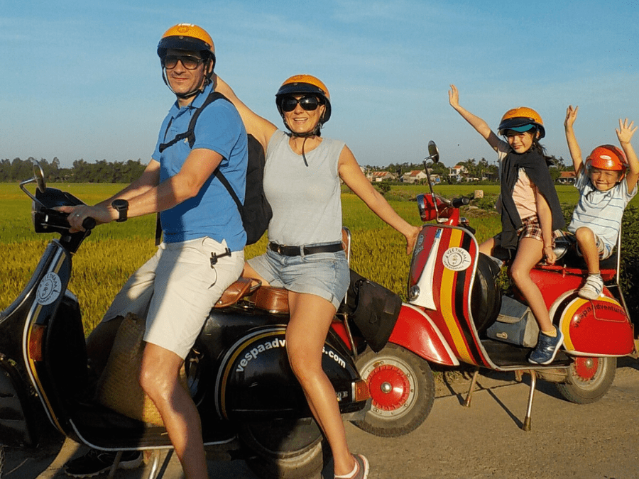 Family biking through the historic streets of Hoi An Ancient Town.