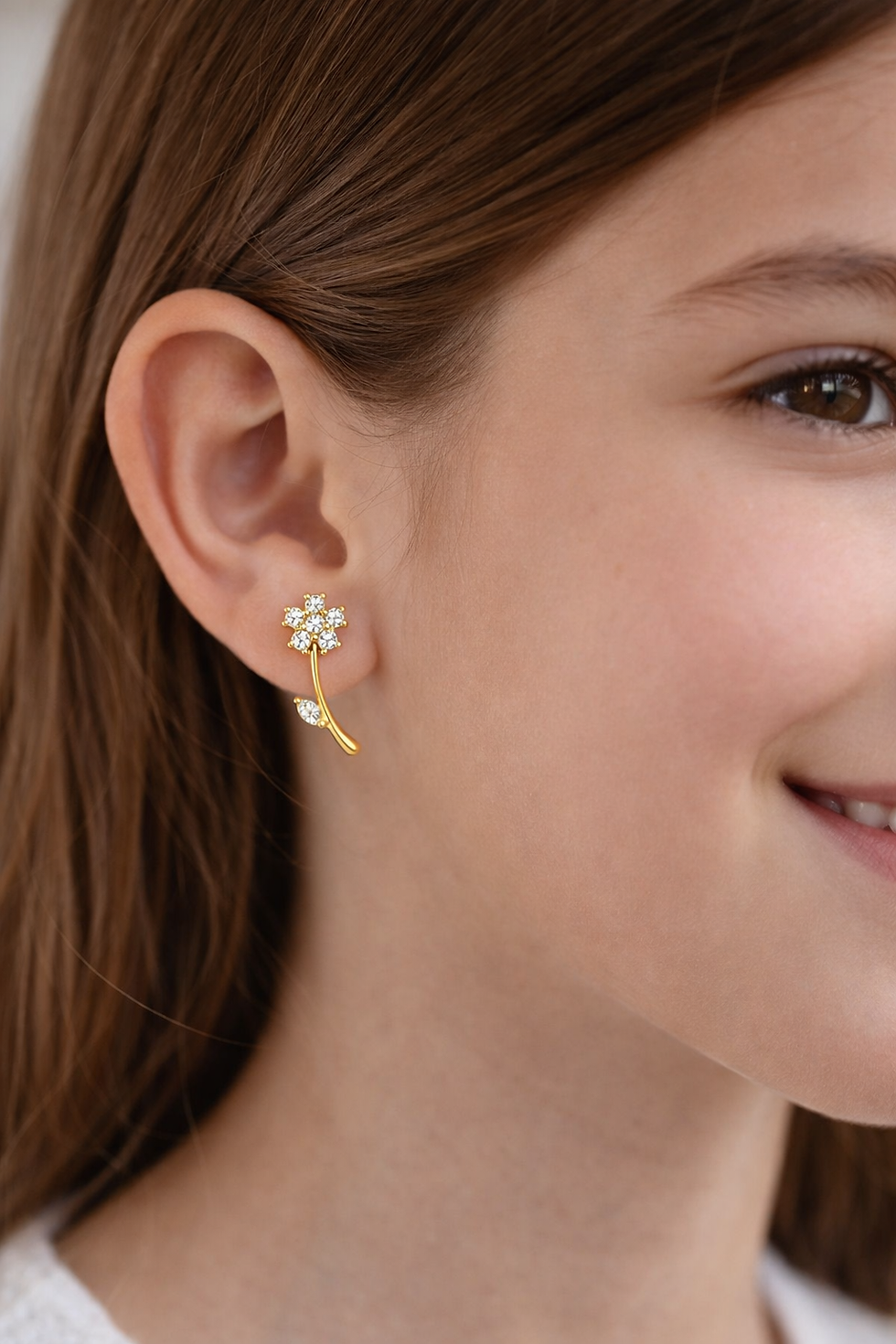 Thumbnail: Flower-shaped stud earrings in 18k yellow gold with cubic zirconia details.