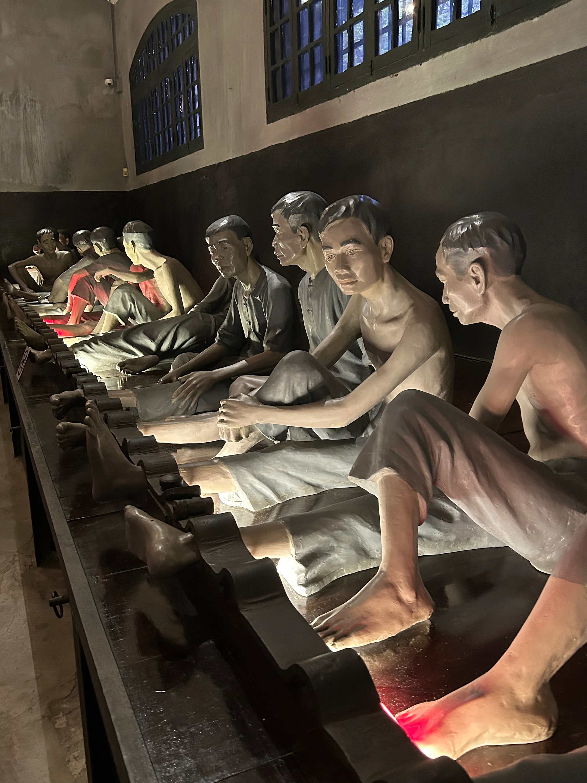 Sculptures of prisoners inside the Hoa Lo Prison in Hanoi