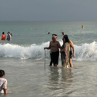 An old man enjoying the sea waves at Radhanagar Beach in Havelock Island