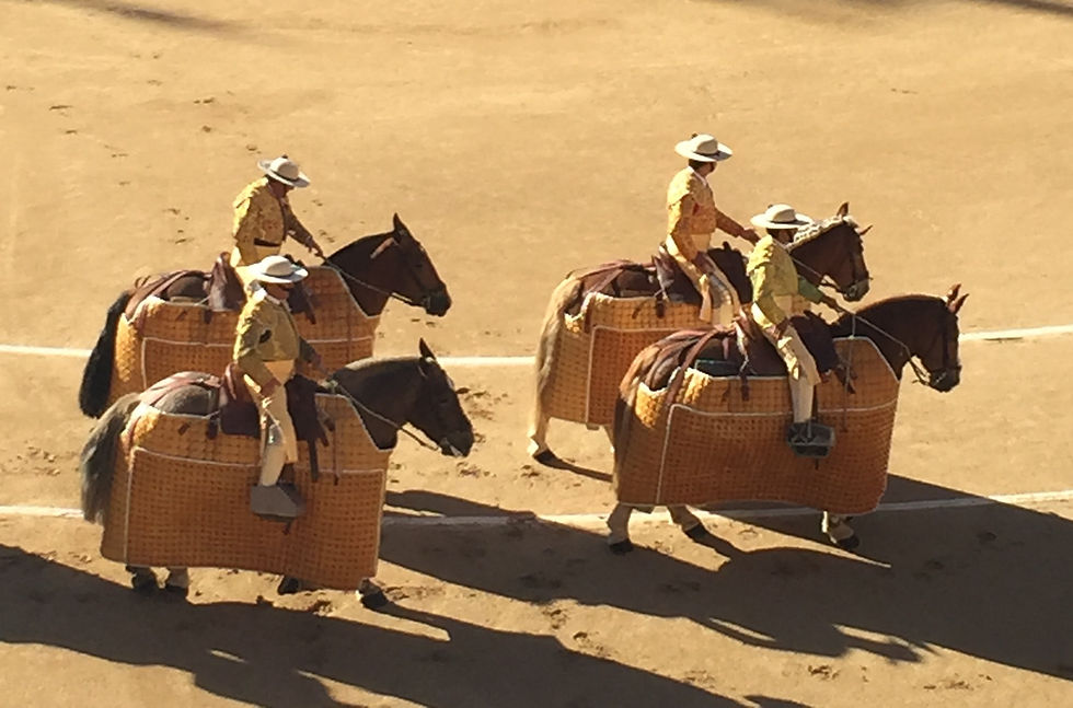Men mounted on horses going around the arena before the bullfight at Plaza de Toros in Madrid