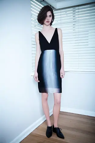 FASHION MODEL IN LIVING ROOM WEARING DRESS WITH ANGLED BUST AND ORGANZA SKIRT WITH OMBRE ILLUMIOUS SKIRT BY GAVIN LOWES NEODIA