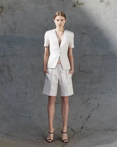 fashion model in skate park pit wearing neodia GAVIN LOWES tailored summer jacket with tailored bermuda shorts