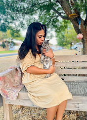 woman kissing cat