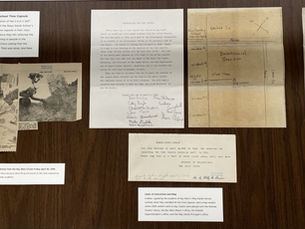 documents laid out on a flat surface with typewritten descriptions.