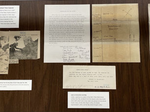 documents laid out on a flat surface with typewritten descriptions.
