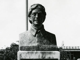 Bust of a person wearing an aviator helmet