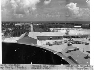 View of buildings from above with a curved wall in the foreground.