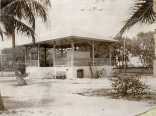 A bandstand in an open area with trees nearby
